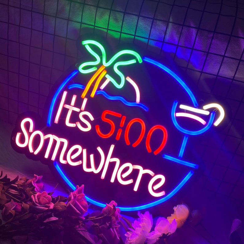 May include: Neon sign with a blue, red and pink colour scheme. The sign reads "It's 5:00 Somewhere" with a palm tree and a cocktail glass.