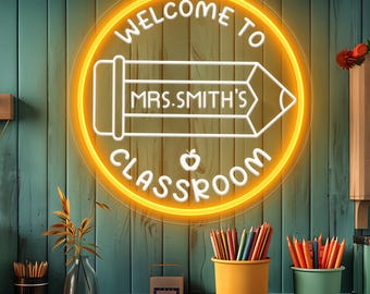 May include: A neon sign with the text "WELCOME TO MRS. SMITH'S CLASSROOM" in a yellow circle with a pencil graphic. The sign is mounted on a teal wooden wall. Pencils in yellow and green containers are on a desk.