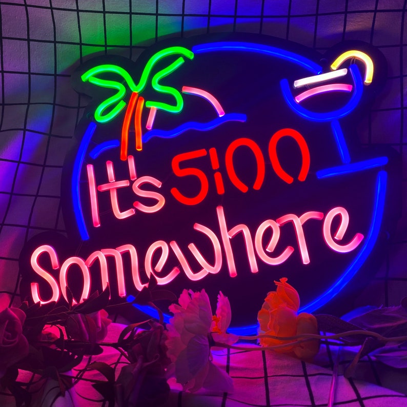 May include: Neon sign with a blue, red and pink colour scheme. The sign reads "It's 5:00 Somewhere" with a palm tree and a cocktail glass graphic.