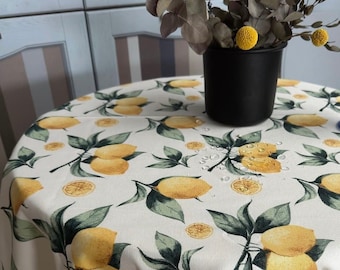 Water-repellent tablecloth with lemons on a milky background. Table setting. Water-repellent effect retains spilled liquids on the surface.