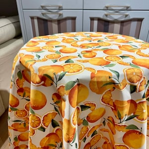 Water-repellent tablecloth Placemat on the table with oranges. Table setting. Water-repellent effect retains spilled liquids on the surface.