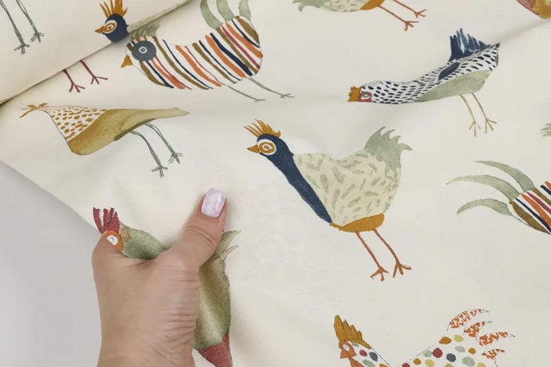 May include: White fabric with a repeating pattern of colorful chickens. The chickens are illustrated in a whimsical style with various colors and patterns.