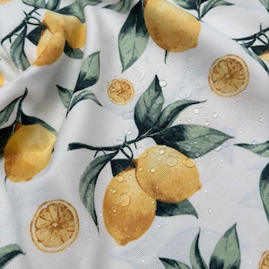 Oval tablecloth Waterproof tablecloth with lemons. Table setting. Water-repellent effect retains spilled liquids on the surface. Oval table.