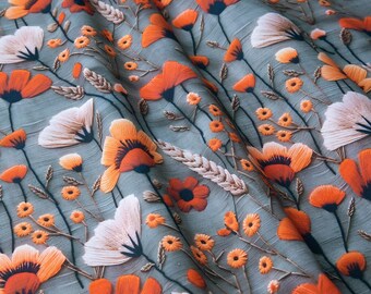 May include: A fabric with a floral pattern featuring orange and white flowers with dark centers, set against a muted teal background. The design includes detailed stems and small yellow flowers, creating a textured, botanical theme.
