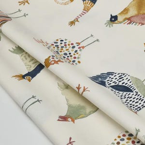 May include: White fabric with a repeating pattern of colorful chickens. The chickens are illustrated in a whimsical style with various colors and patterns.