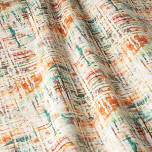 May include: Abstract fabric with a white background and a colorful pattern of orange, green, and blue lines and shapes.