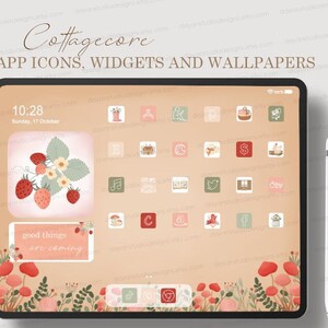 Puede incluir: La pantalla de una tableta digital muestra un conjunto de iconos de aplicaciones con temática cottagecore. Los iconos están dispuestos en una cuadrícula y presentan ilustraciones de flores, casas y otros elementos cottagecore. El fondo es de color melocotón suave con un borde floral. El texto "Cottagecore APP ICONS, WIDGETS AND WALLPAPERS" está en la parte superior de la pantalla. La hora es 10:28 y la fecha es domingo 17 de octubre.