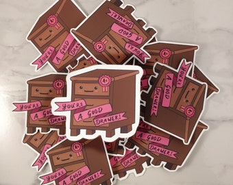 May include: A set of nine stickers featuring a cartoon dresser with the text "You're a good drawer!" in pink lettering. The stickers are brown with pink accents and have a glossy finish.