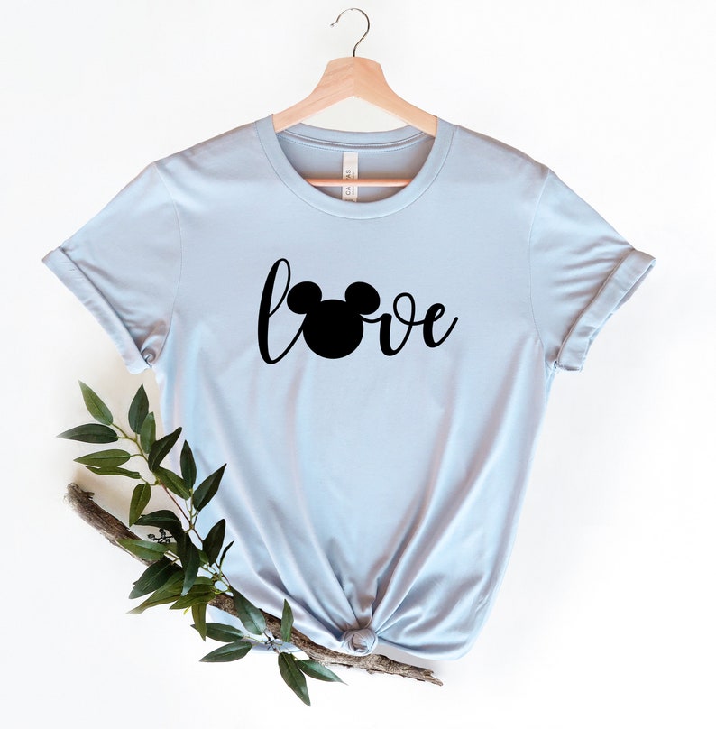 May include: Light blue t-shirt with a black Mickey Mouse head and the word "love" in a cursive font.