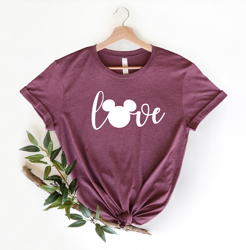May include: Burgundy t-shirt with a white Mickey Mouse head and the word "love" in a cursive font.
