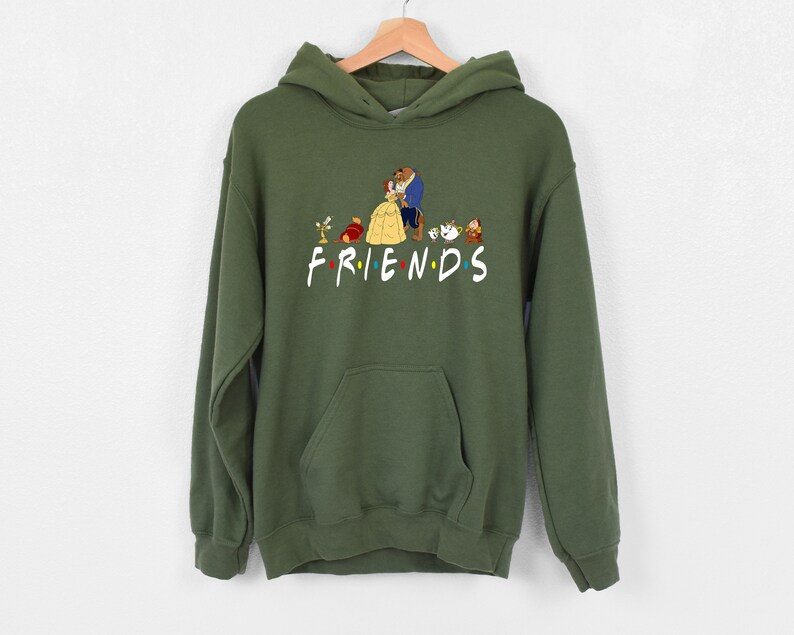May include: Green hooded sweatshirt with a graphic print of characters from the Disney movie Beauty and the Beast. The text "FRIENDS" is printed below the characters.