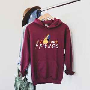 May include: Burgundy hoodie with a graphic of Belle and the Beast from Beauty and the Beast, along with other characters from the movie. The graphic says "FRIENDS".