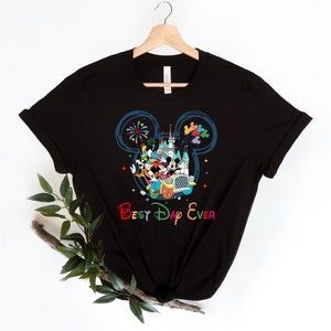 May include: Black t-shirt with a colorful graphic of Mickey Mouse and friends in a car with the text "Best Day Ever" in rainbow colors.