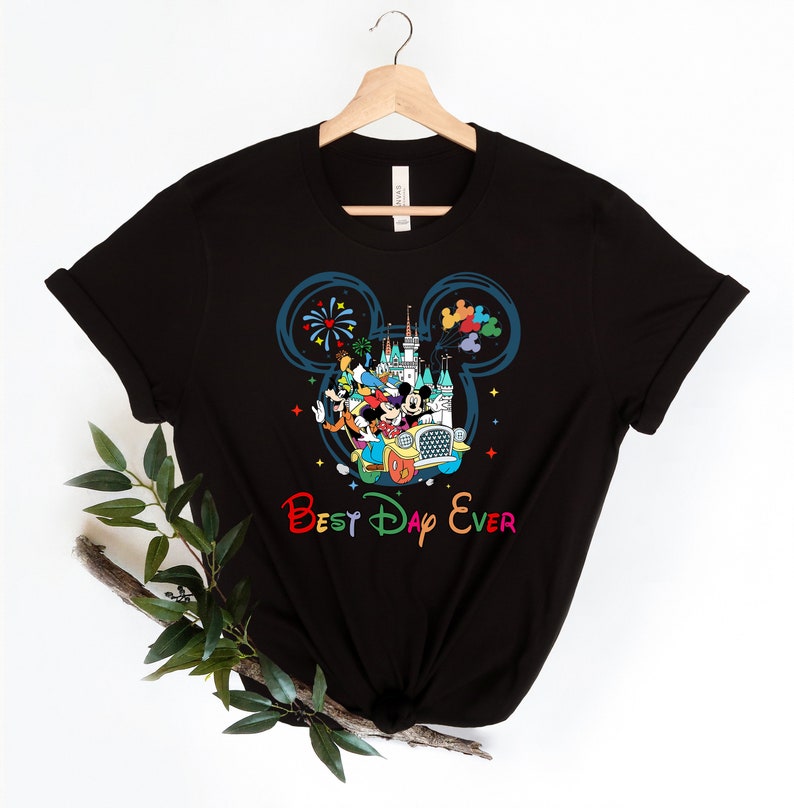 May include: Black t-shirt with a colorful graphic of Mickey Mouse and friends in a car with the text "Best Day Ever" in rainbow colors.