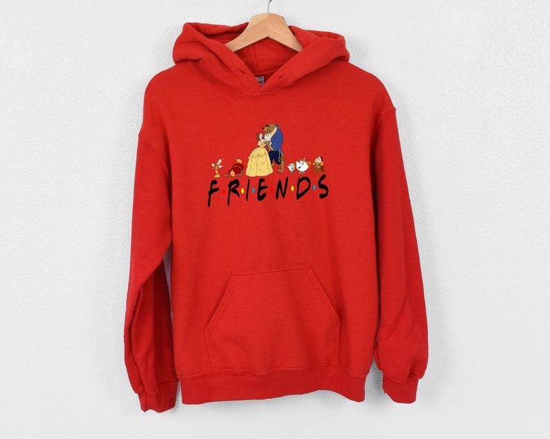May include: Red hooded sweatshirt with a graphic of Belle and the Beast from Beauty and the Beast, along with other characters from the movie. The text "FRIENDS" is printed below the graphic.