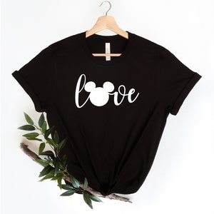 May include: Black t-shirt with a white Mickey Mouse head and the word "love" printed on the front.