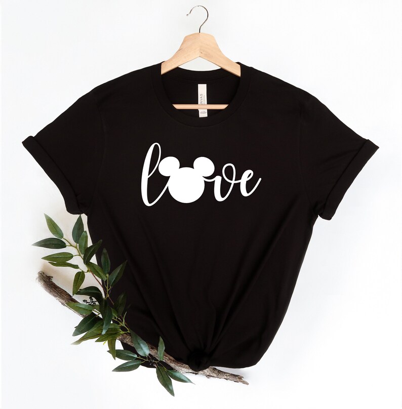 May include: Black t-shirt with a white Mickey Mouse head and the word "love" printed on the front.