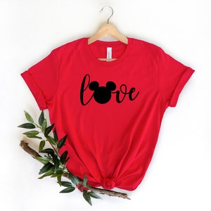 May include: Red t-shirt with a black Mickey Mouse head and the word "love" in a cursive font.