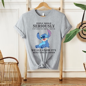 May include: Gray t-shirt with a blue Stitch character from Lilo & Stitch. The text on the shirt reads "People should seriously stop expecting normal from me. We all know it's never going to happen."