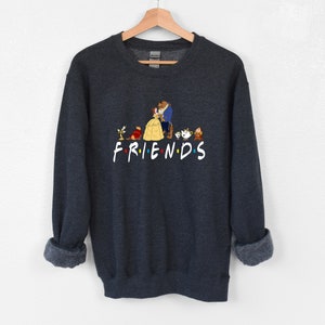 May include: Dark gray sweatshirt with a graphic print of characters from the animated film Beauty and the Beast. The graphic includes Belle, Beast, Lumiere, Cogsworth, Mrs. Potts, Chip, and the text "FRIENDS".