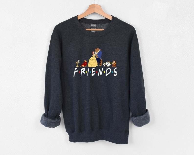 May include: Dark gray sweatshirt with a graphic print of characters from the animated film Beauty and the Beast. The graphic includes Belle, Beast, Lumiere, Cogsworth, Mrs. Potts, Chip, and the text "FRIENDS".