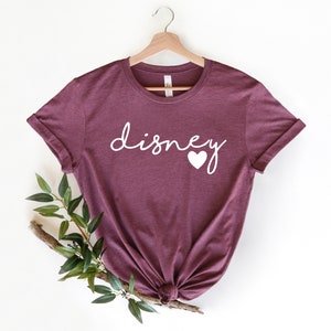 May include: Burgundy t-shirt with white text that says "disney" with a white heart after the "y".