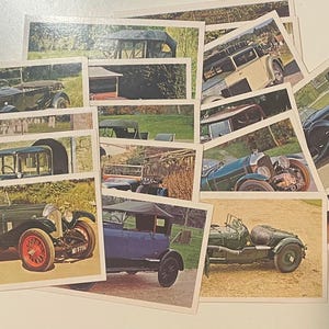 May include: A collection of vintage car trading cards featuring various makes and models of classic cars. The cards are printed in color and show the cars in different settings.