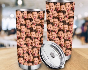 May include: Two stainless steel tumblers with a pattern of a person's face repeated over the entire surface. The tumblers have lids.