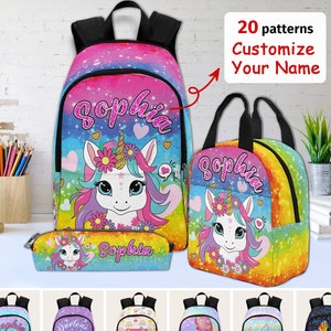 May include: A set of three personalized backpacks featuring a unicorn design with rainbow colors and glitter. The backpacks are available in different sizes and include a pencil case. The text "Sophia" is printed on the backpacks.