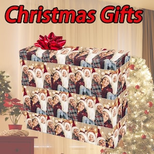 May include: A Christmas gift wrapping paper with a repeating pattern of a family of three wearing Santa hats. The paper is brown with a white and red plaid pattern. The family is smiling and looking at the camera. The text "Christmas Gifts" is at the top of the image.