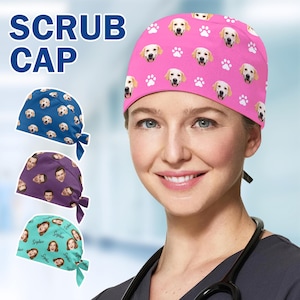 May include: A pink scrub cap featuring a pattern of golden retriever faces and paw prints. The image also shows three other scrub caps: blue with golden retriever faces, purple with faces, and teal with faces and the name "Sophie". The words "SCRUB CAP" are in the upper left.