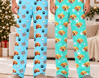 May include: Two pairs of lounge pants. The left pair is light blue with a repeating pattern of cat faces and black paw prints. The right pair is teal with a repeating pattern of golden retriever faces and white bone and paw print icons.