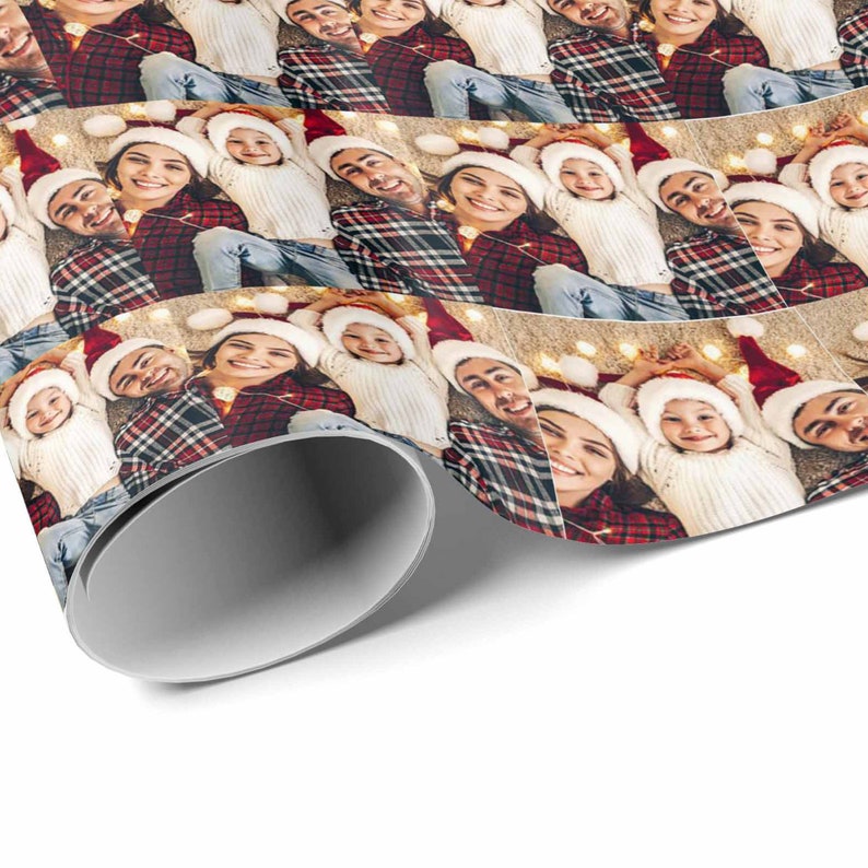May include: A repeating pattern of a family wearing Santa hats, smiling and looking at the camera. The family is wearing red and white plaid shirts, white sweaters, and blue jeans. The background is a white surface with string lights.