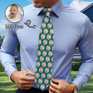 May include: A green tie with a repeating pattern of a baby's face. The tie is being worn by a person. The text "1-10 faces" is visible in the image.