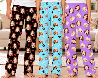 May include: Three pairs of pajama pants featuring custom photo prints. The black pair has repeating faces and red hearts. The light blue pair displays cat and dog faces with paw prints. The purple pair features repeating baby and adult faces.