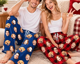 May include: Custom pajama pants featuring a repeating pattern of printed faces of people and a golden retriever dog. The pants have a white drawstring waist. One pair is solid blue, and the other pair features a red and black buffalo plaid pattern.