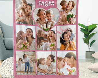 May include: Pink fleece blanket with a collage of photos of a mother and her children. The blanket has a heart shape in the center with the words "Love you Mom" written inside.