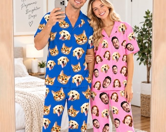 May include: A set of blue pajamas with a repeating pattern of cat and dog faces, and a set of pink pajamas with a repeating pattern of human faces and dog faces. Both sets feature short-sleeved button-down shirts and matching long trousers.