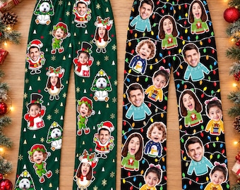 May include: Two pairs of pajama pants featuring custom photo faces. The left pair is green with gold snowflakes and cartoon characters in holiday outfits. The right pair is black with a colorful string of Christmas lights and photo faces.