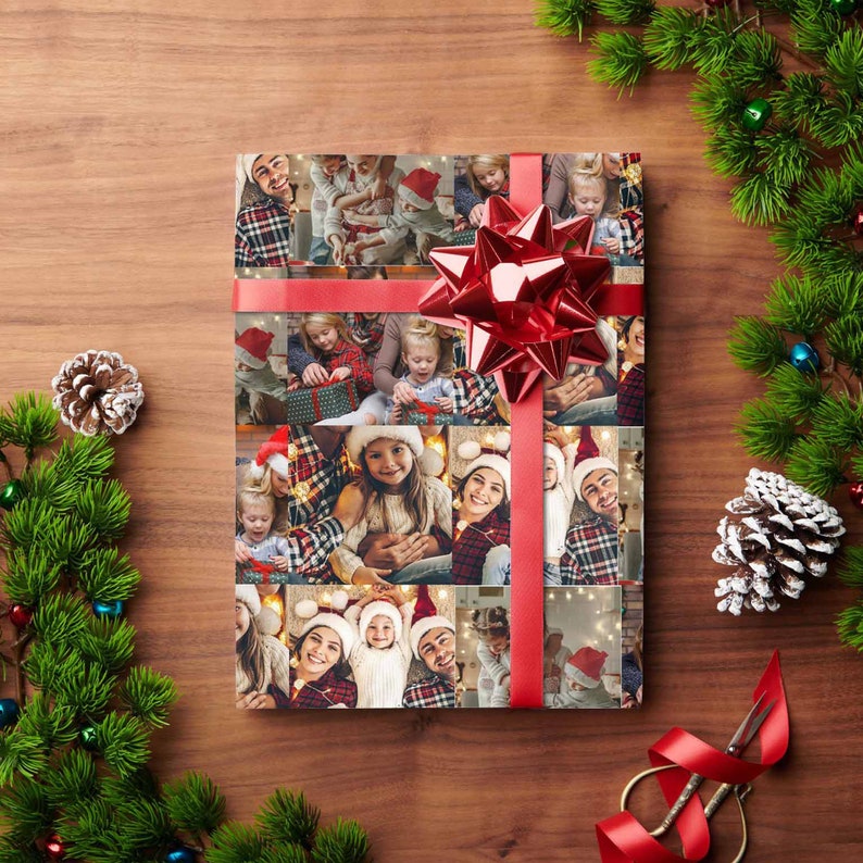 May include: A red and white Christmas wrapping paper with a collage of family photos. The photos show a family celebrating Christmas together. The wrapping paper is tied with a red ribbon and bow.