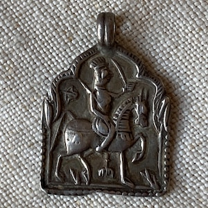 May include: A white ceramic mug with a black handle and the text "But First, Coffee" in a bold, black font. The mug is set against a plain white background, highlighting its simple design.