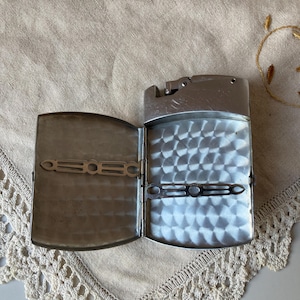 May include: A white ceramic mug with a black handle and the text "But First, Coffee" in a handwritten style. The mug is on a white surface. The mug is 4 inches tall.