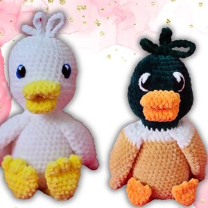 May include: Two crocheted stuffed duck toys. One is white with yellow feet and a yellow beak. The other is brown with orange feet and an orange beak. The duck with the brown body has a green head.