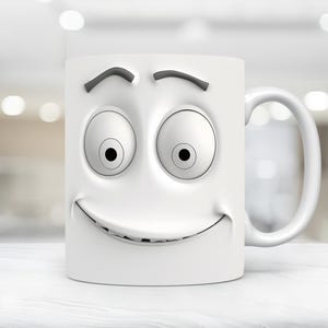 May include: White ceramic mug with a cartoon face printed on the front. The face has large eyes, a wide smile, and raised eyebrows.