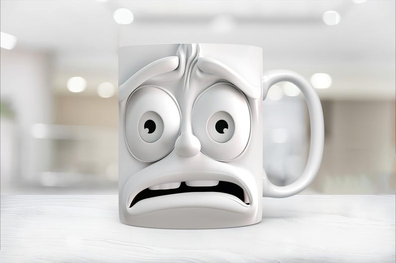 May include: White ceramic coffee mug with a cartoon face expressing fear. The mug has large eyes, a wide mouth, and a furrowed brow.