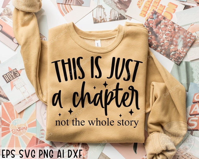 May include: A tan sweatshirt with the text "This is just a chapter not the whole story" in black lettering.