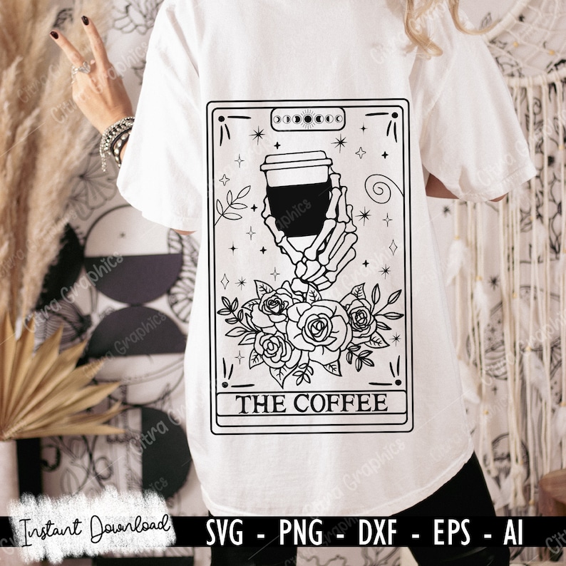 May include: Black and white illustration of a tarot card with a skeleton hand holding a coffee cup. The card is labelled "THE COFFEE" and is surrounded by roses and stars.