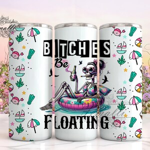 Op de afbeelding: Een witte roestvrijstalen tumbler met een kleurrijk ontwerp met een skelet in een roze en gele binnenband, dat een biertje en een sigaret vasthoudt. De tekst "Bitches Be Floating" is op de tumbler gedrukt.