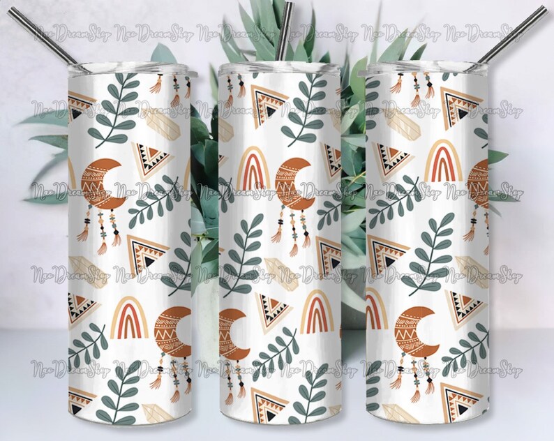 May include: Three stainless steel tumblers with a white background and a repeating pattern of orange, brown, and white geometric shapes, crescent moons, and green leaves.