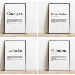 May include: Four black and white framed prints with the definitions of four dog breeds: Cockapoo, German Shepherd, Labrador, and Chihuahua. Each definition includes the phrase "happiness starts with a wet nose and ends with a tail."